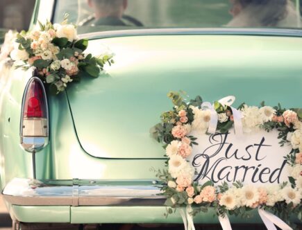 Vintage Hochzeitsauto mit Blumenschmuck und Just Married Schild – perfekte Kulisse zur Feier mit Ehering Gold