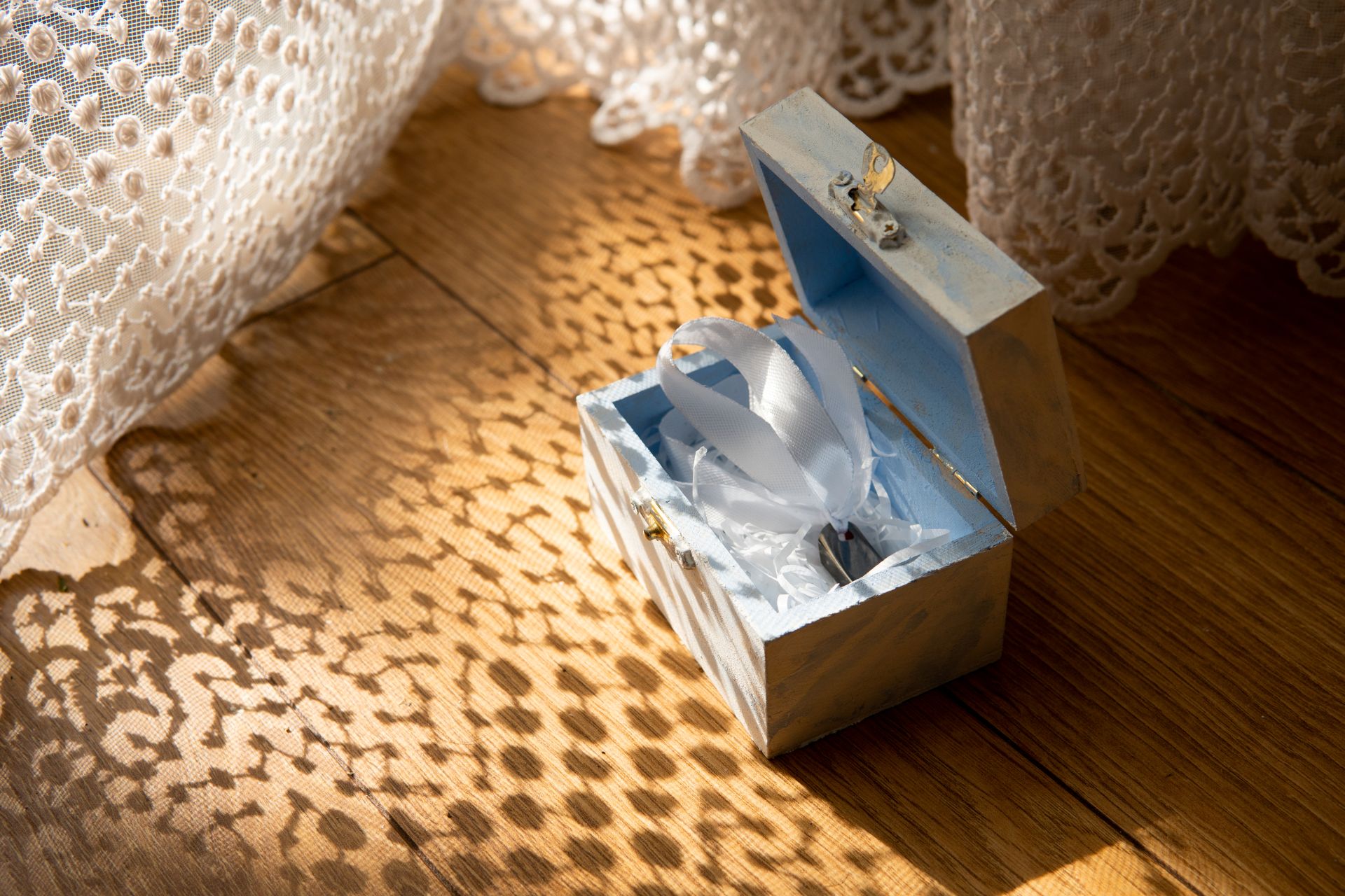 Holzbox im warmen Licht mit dekorativem Schattenmuster, ideal als stimmungsvolles Motiv fuer einen Artikel ueber Antik Schmuck und Shopping